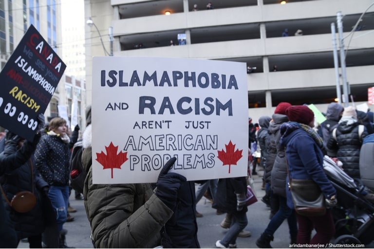 Canadian protestors marching with signs