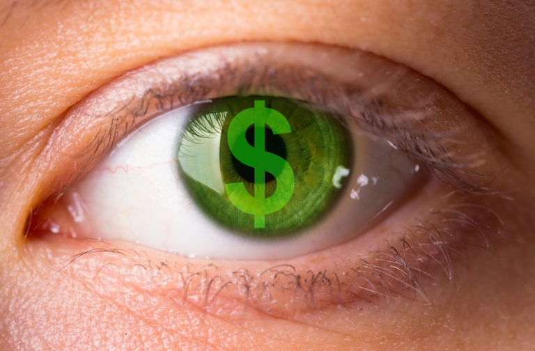 Woman's eye reflecting money symbol